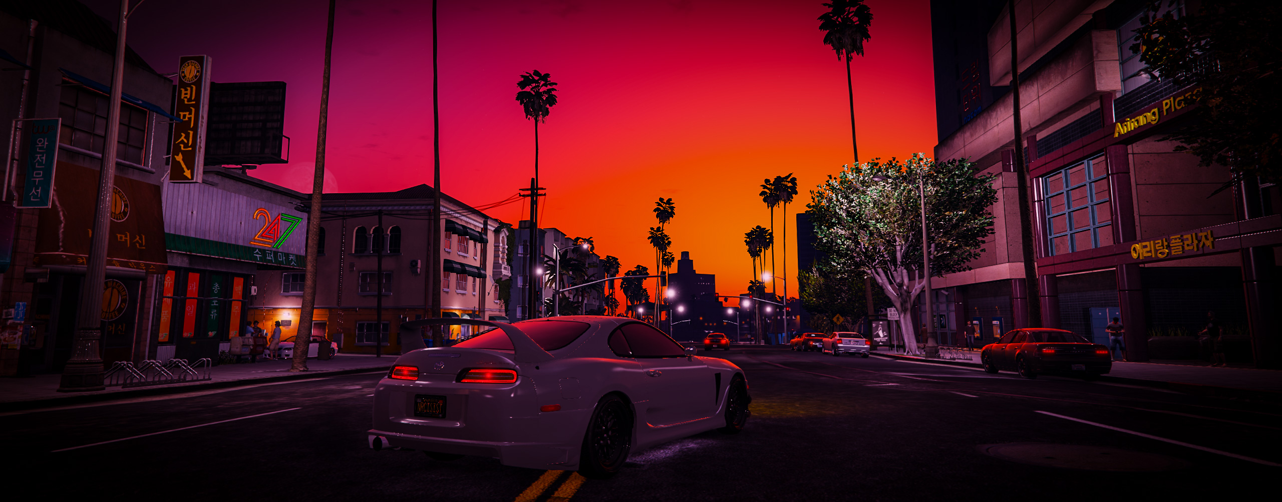 White Toyota Supra cruising a neon-lit Koreatown street under a vivid red sunset